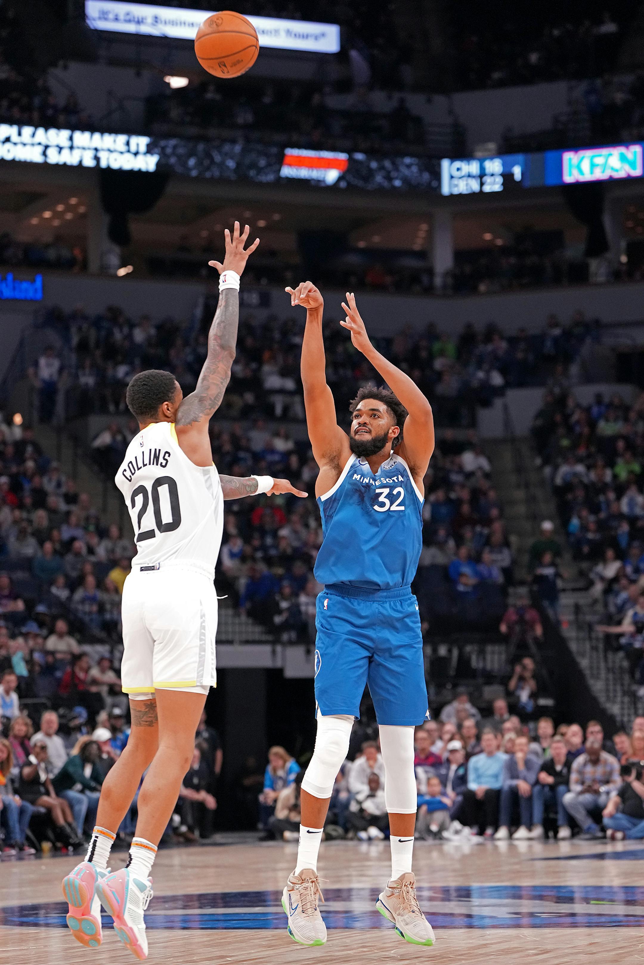 Minnesota Timberwolves center Karl-Anthony Towns (32) shoots against Utah Jazz forward John Collins (20) during the second half of the game.
