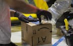 A worker tapes a box while packing items on Cyber Monday at the Amazon Fulfillment Center on Nov. 28, 2016 in San Bernardino, Calif. (Gina Ferazzi/Los