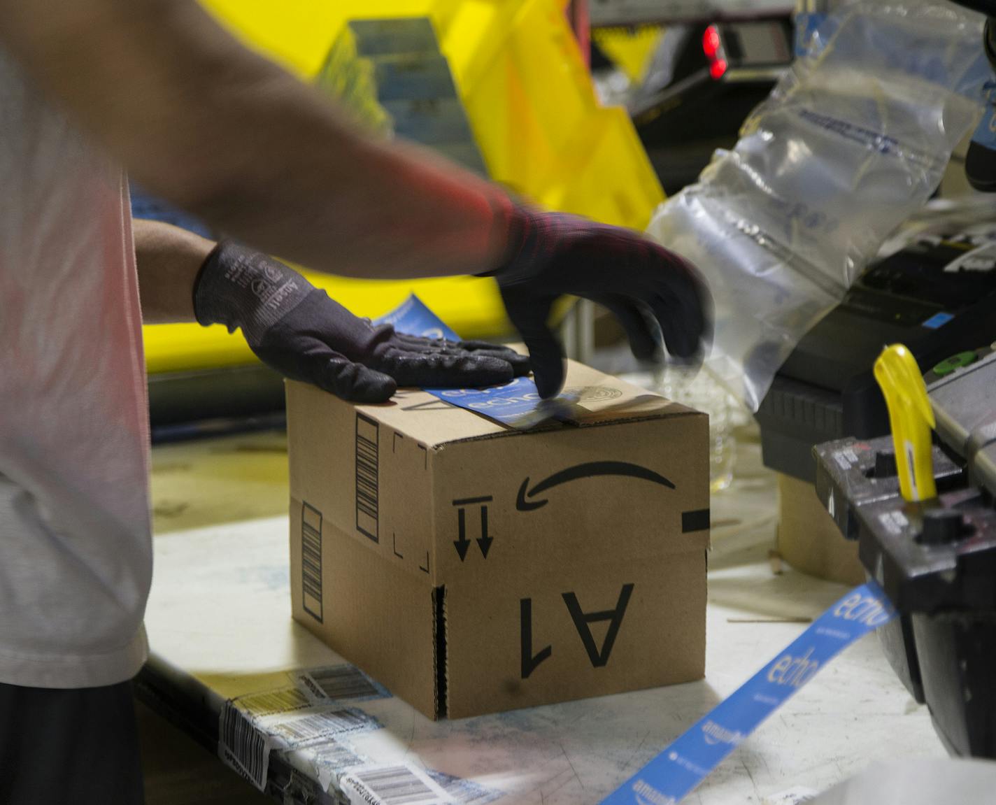 A worker tapes a box while packing items on Cyber Monday at the Amazon Fulfillment Center on Nov. 28, 2016 in San Bernardino, Calif. (Gina Ferazzi/Los Angeles Times/TNS) ORG XMIT: 1194093