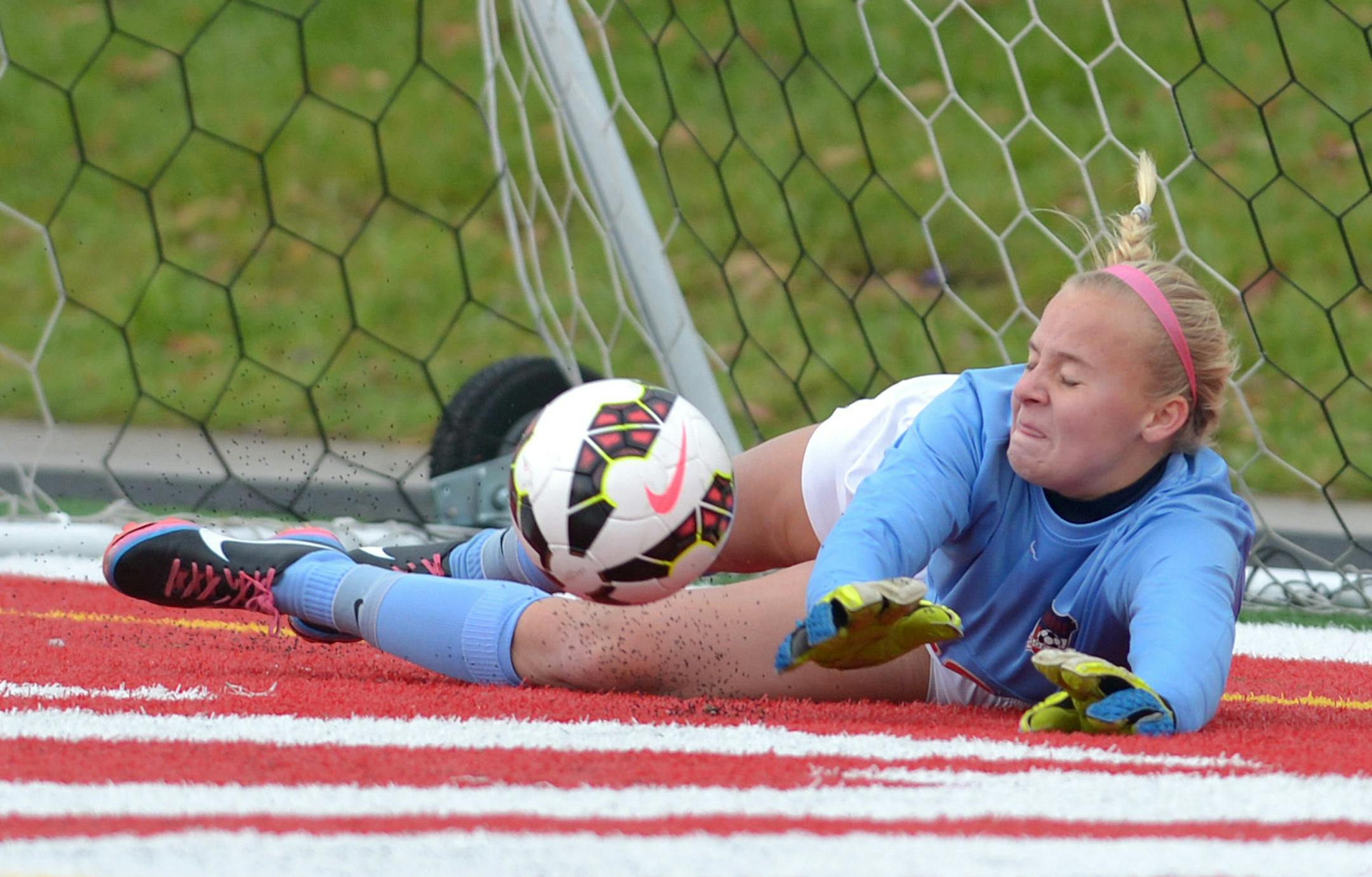 Orono goalkeeper Jessica Woessner blocks Minneapolis Washburn's Anna Polacek's final shot of the shoot out to win the Class 1A Girls' championship game Thursday, October 30 at Husky Stadium in St. Cloud. Orono won the game after a shoot out. ] (SPECIAL TO THE STAR TRIBUNE/BRE McGEE) **Anna Polacek (not pictured, white, 23), Jessica Woessner (goalkeeper)