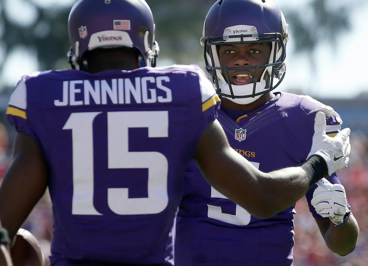 Teddy Bridgewater (5) celebrates with Greg Jennings (15) after they connected for a touchdown in the third quarter against the Buccaneers Sunday, Oct. 26, 2014 at Raymond James Stadium in Tampa, Fla. The Vikings came out on top 19-13 in overtime. (Carlos Gonzales/Minneapolis Star Tribune/MCT) ORG XMIT: 1159204