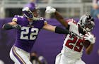 Minnesota Vikings free safety Harrison Smith (22) pushed Atlanta Falcons running back Ito Smith (25) out of bounds as he ran with the ball in the firs