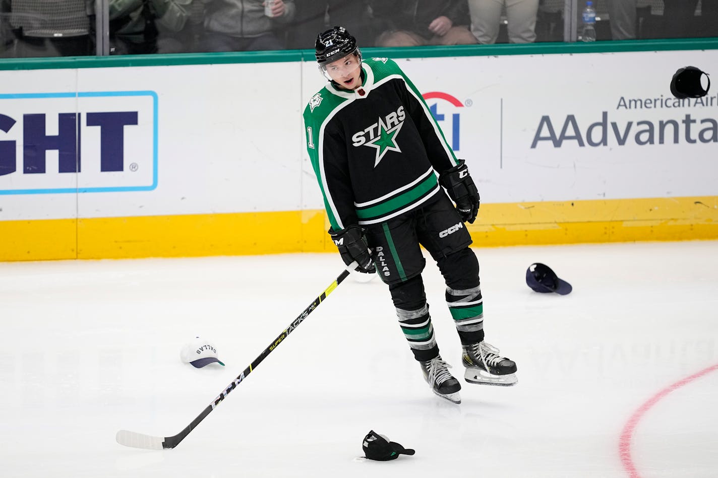 Dallas Stars left wing Jason Robertson skates past hats thrown onto the ice after Robertson scored his third goal of the night against the Anaheim Ducks, during the third period of an NHL hockey game Thursday, Dec. 1, 2022, in Dallas. (AP Photo/Tony Gutierrez)