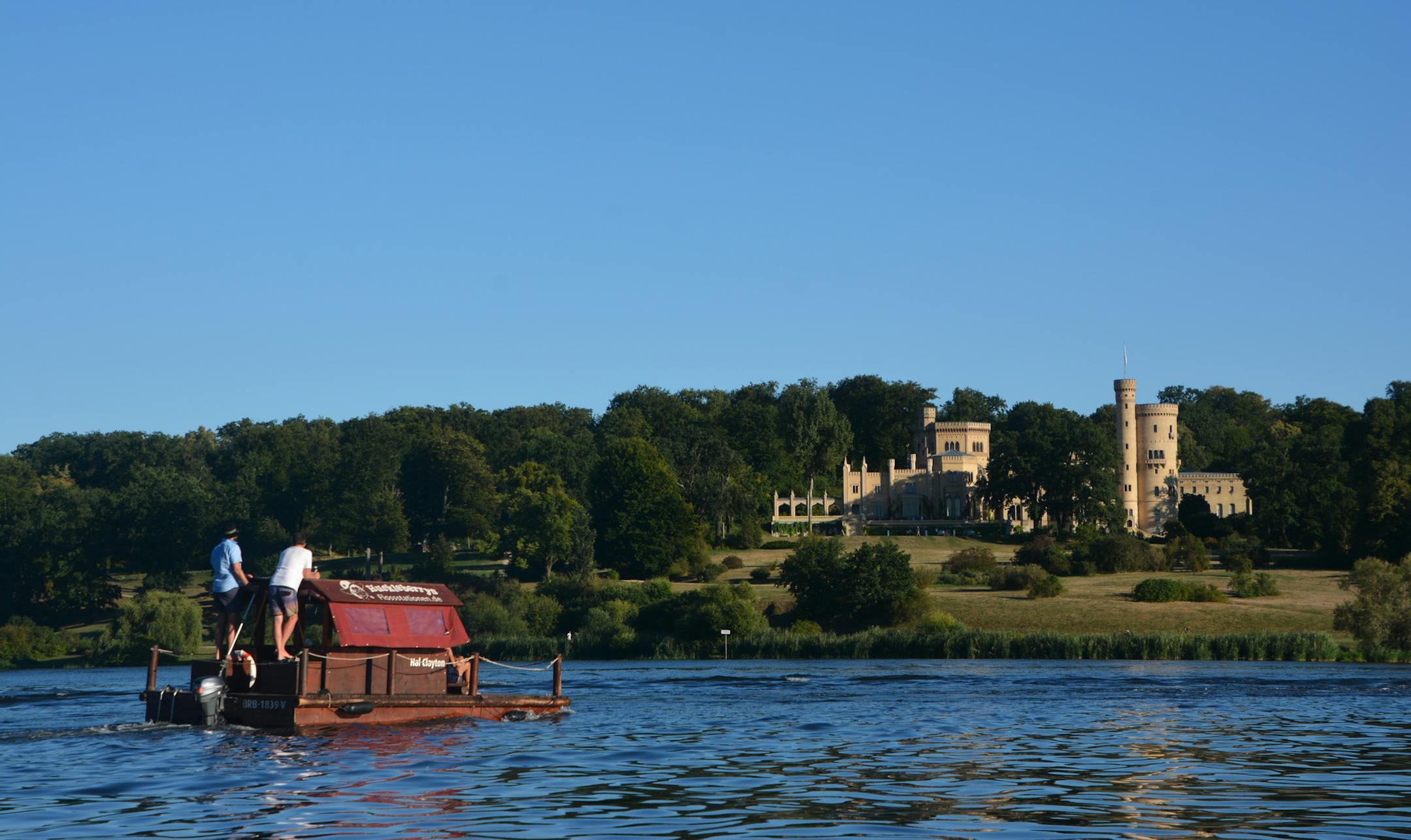 A pair of men pilot a boat on the Havel River past Babelsberg Palace, the onetime summer residence of the King and Queen of Prussia. Matt McKinney * matt.mckinney@startribune.com
