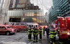 New York City Fire Department vehicles sit on Fifth Avenue in front of Trump Tower, in New York, Monday, Jan. 8, 2018. The department says the fire st