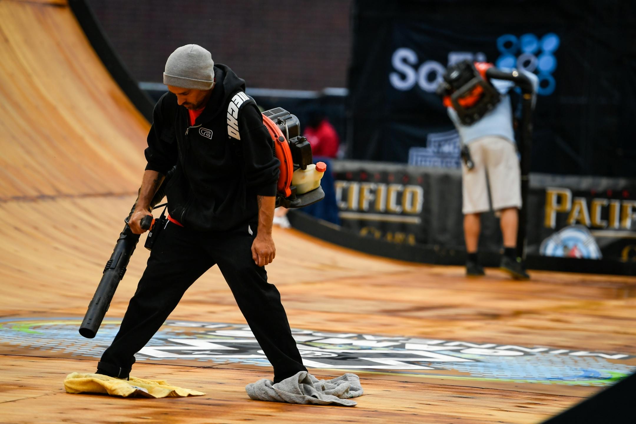 Workers attempted to clear water from the vert ramp Thursday after a short rain fall.