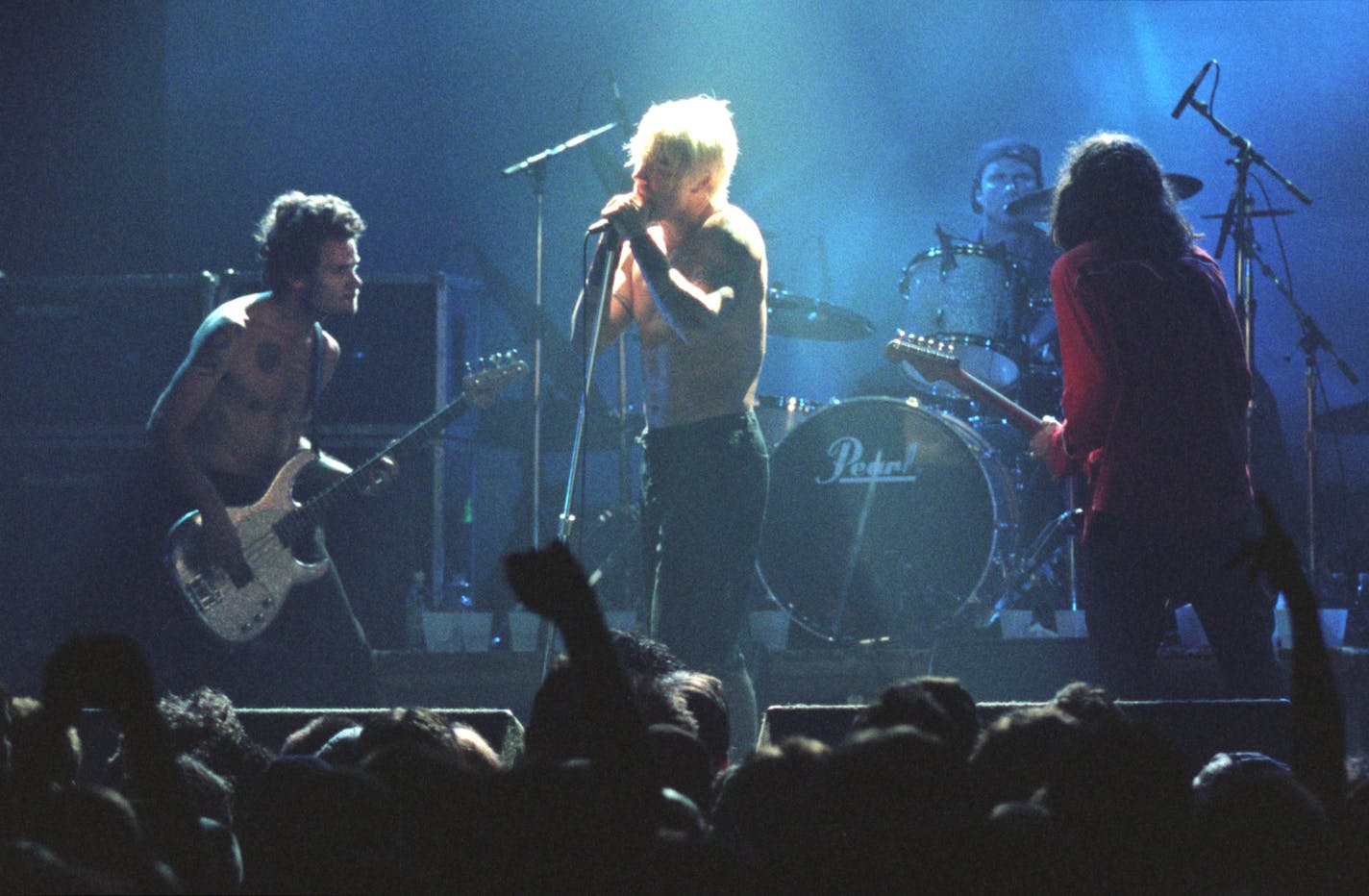 The Red Hot Chili Peppers played a free concert for high school students at First Ave. Thursday night. The show was promoted as a pro-tolerance event. — Anthony Kiedis sang the bandís hit ìUnder the Bridgeî during their encore. Others are, from left, the bassist, Flea, drummer Chad Smith guitarist John Frusicante. (names are all cq except Frusicante)