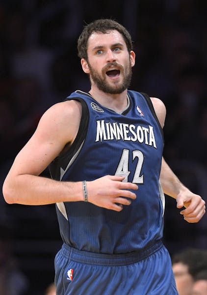 Minnesota Timberwolves forward Kevin Love looks on after scoring during the first half of an NBA basketball game against the Los Angeles Lakers, Sunda