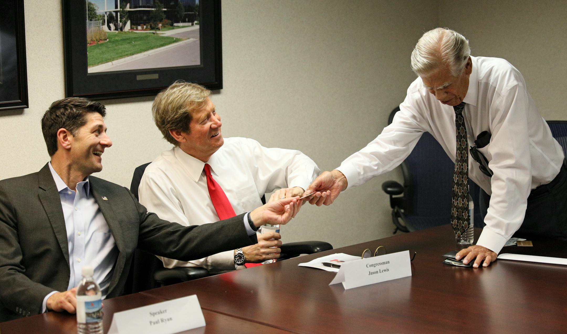 House Speaker Paul Ryan visited Minnesota on Monday, where he spent time at Best Buy HQ with Rep. Erik Paulsen, then held a roundtable discussion with Rep. Jason Lewis at Ames Construction in Burnsville with business leaders focused on career and technical education. Here, Paul Ryan and Jason Lewis take a look at Dick Ames union card that he said doubled his wages from just over a 1$ per hour to over 2$ when he joined the union. ] BRIAN PETERSON ¥ brian.peterson@startribune.com Burnsville, MN 07