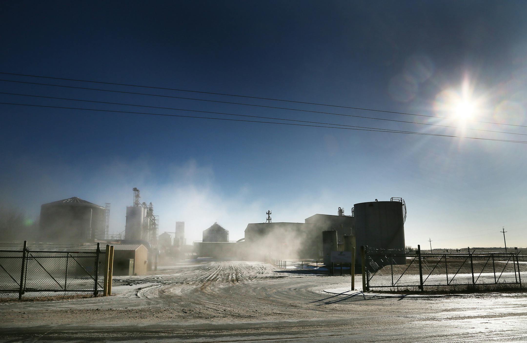 Steam from a nearby cooling tower shrouded the ethanol plant recently at Buffalo Lake Advance Biofuels in Buffalo Lake, Minn.