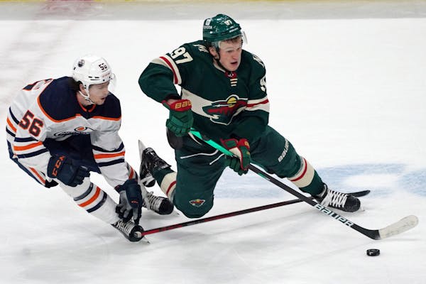 Edmonton's Kailer Yamamoto defends as the Wild's Kirill Kaprizov controls the puck during the second period