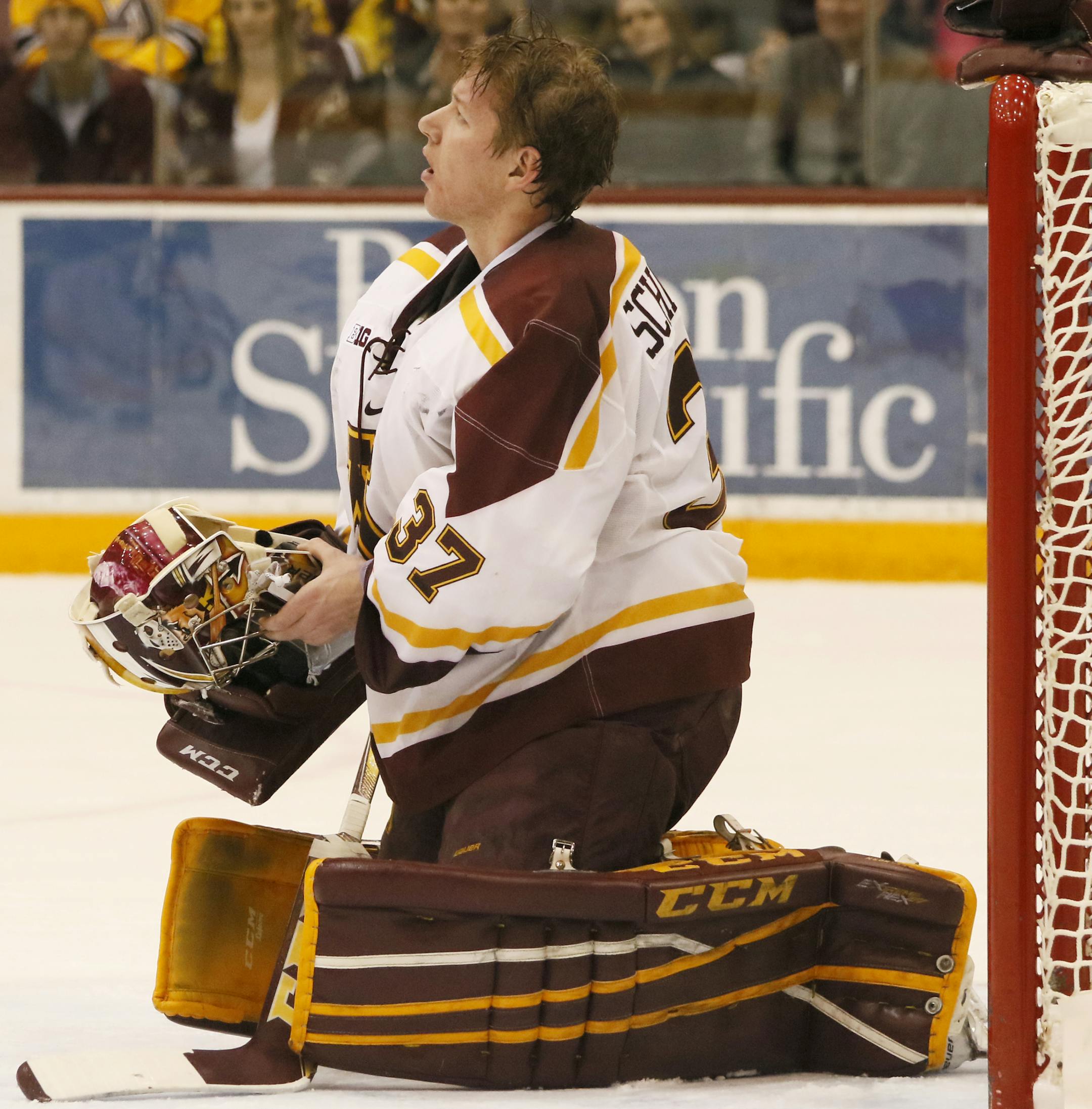 Minnesota's Eric Schierhorn (37) watches the replay of a third goal scored on him by Wisconsin during the second period. ] MATT WEBER •