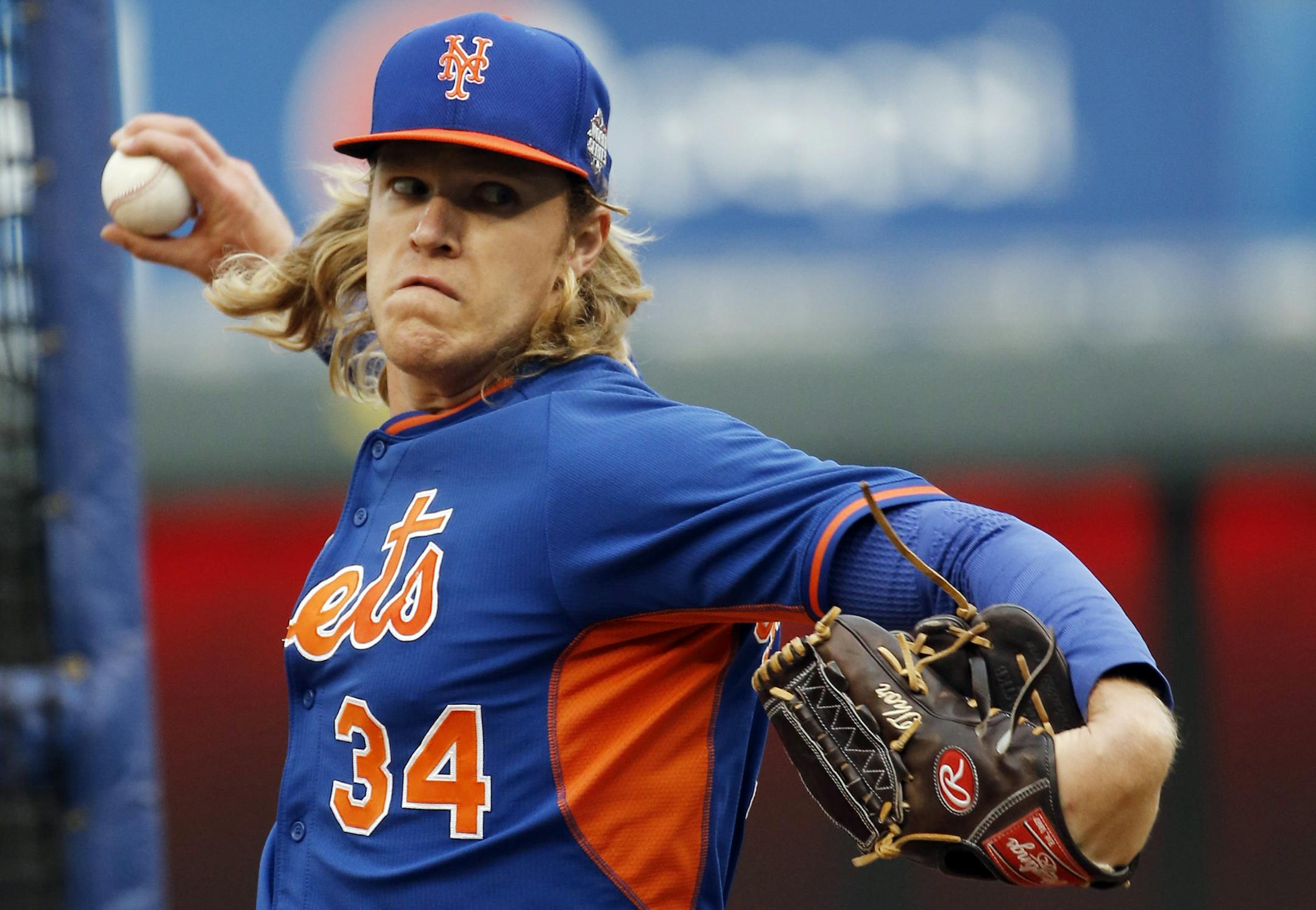 New York Mets pitcher Noah Syndergaard has the name Thor monogrammed on his glove as he throws at batting practice for the Major League Baseball World Series against the Kansas City Royals Monday, Oct. 26, 2015, in Kansas City, Mo. (AP Photo/Matt Slocum)