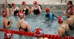 Suhan Mohamed, in swimsuit with blue arms, did a cheer in the water with her fellow teammates before a swim meet at Apollo High School in St. Cloud, M