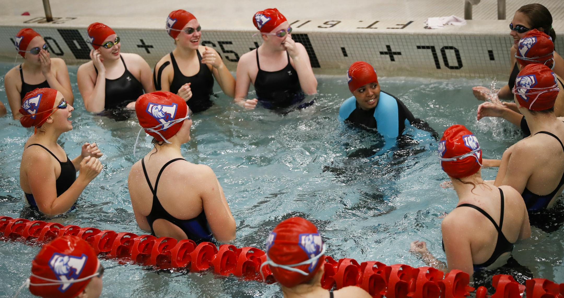 Suhan Mohamed, in swimsuit with blue arms, did a cheer in the water with her fellow teammates before a swim meet at Apollo High School in St. Cloud, Minn., on Thursday, October 5, 2017. Nimo Gohe (not pictured) and Suhan Mohamed just learned to swim this summer and are now on the Apollo High School swim team.] RENEE JONES SCHNEIDER • renee.jones@startribune.com