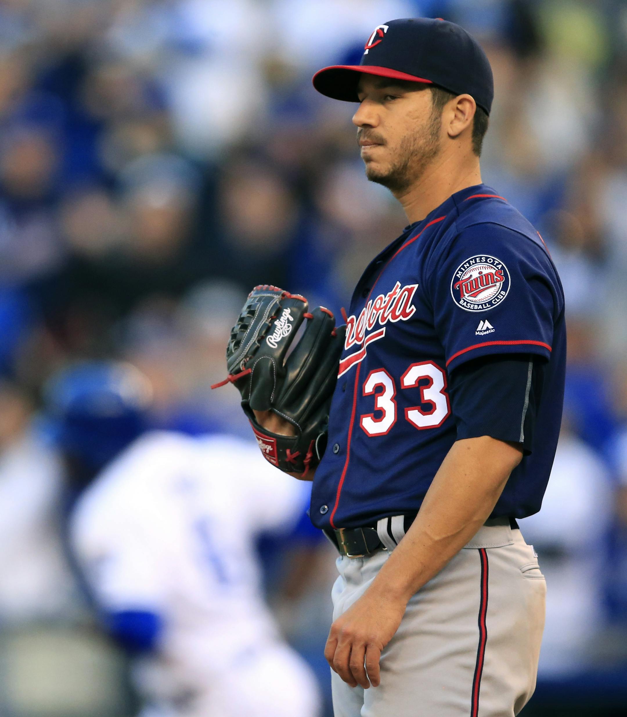 Minnesota Twins starting pitcher Tommy Milone (33) stands on the mound after giving up a home run to Kansas City Royals' Lorenzo Cain during the fourth inning of a baseball game at Kauffman Stadium in Kansas City, Mo., Saturday, April 9, 2016. Milone gave up back-to-back home runs in the inning. (AP Photo/Orlin Wagner)