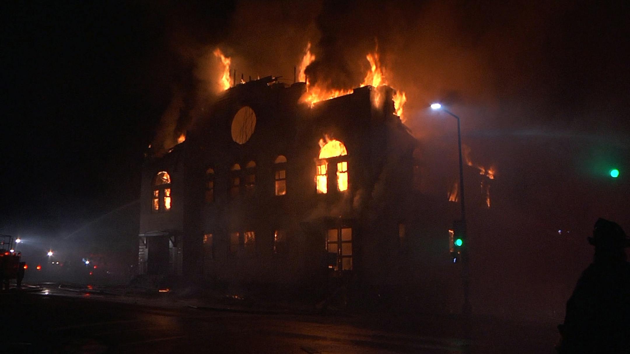 An overnight fire engulfed and destroyed a synagogue in downtown Duluth and continued to burn many hours later Monday morning. Photo courtesy KBJR-TV.