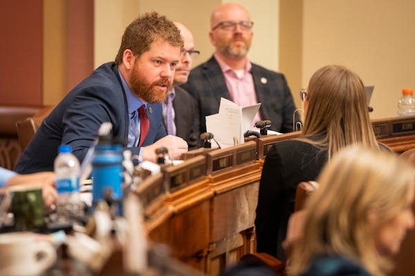Rep. Zack Stephenson, DFL-Coon Rapids, sponsor of the bill to legalize marijuana, talks to other lawmakers on the House floor on Monday, April 24, 202