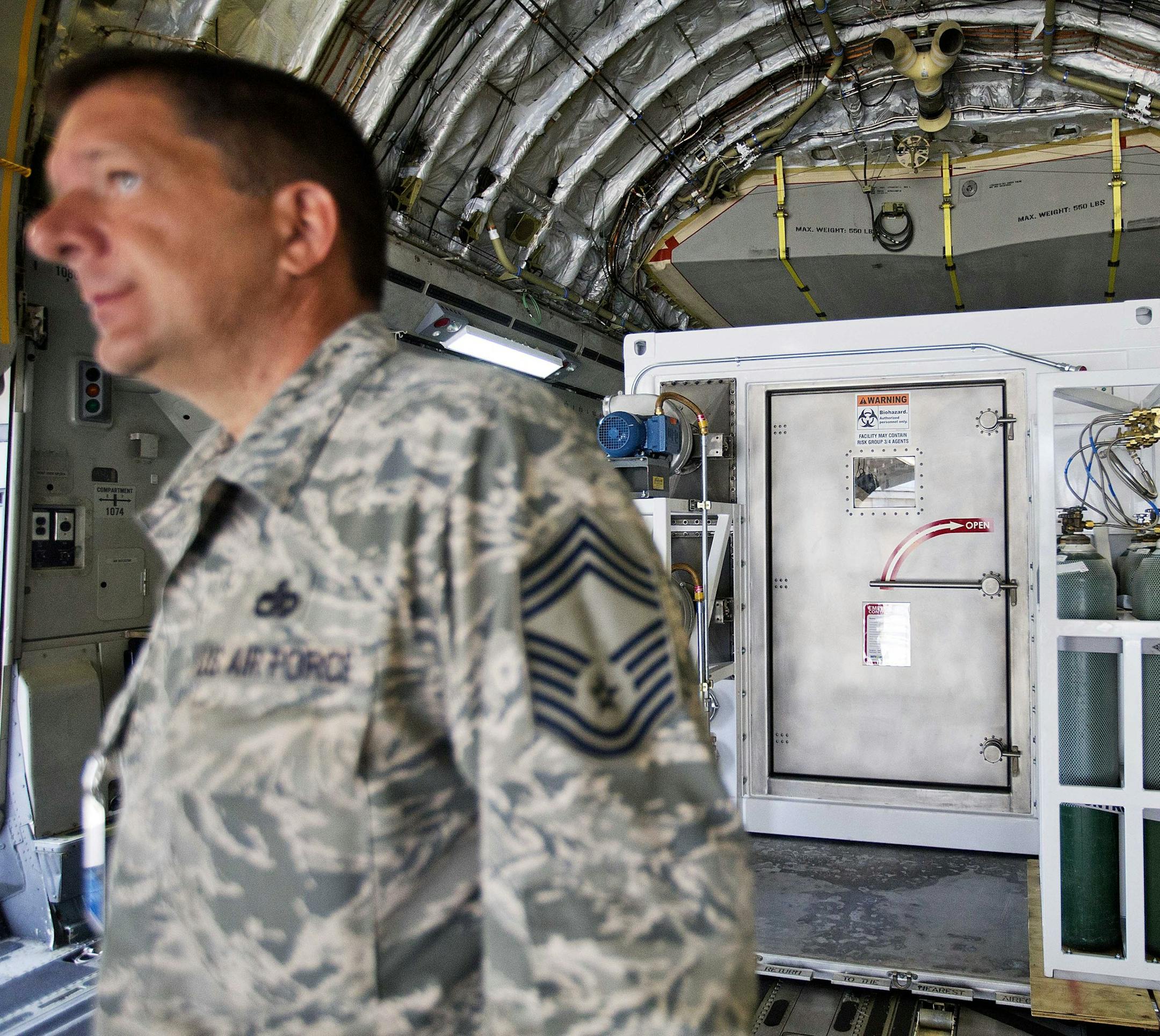 CORRECTS TO C-17 FROM B-17 - A medevac biocontainment unit is displayed aboard a C-17 military transport plane at Dobbins Air Force Reserve Base during a media tour, Tuesday, Aug. 11, 2015, in Marietta, Ga. The State Department and partners unveiled the new public-private containerized biocontainment system for highly contagious pathogens Tuesday. The first of their kind units, owned and operated by the U.S. State Department and housed at Dobbins, can roll on and off planes to help evacuate and