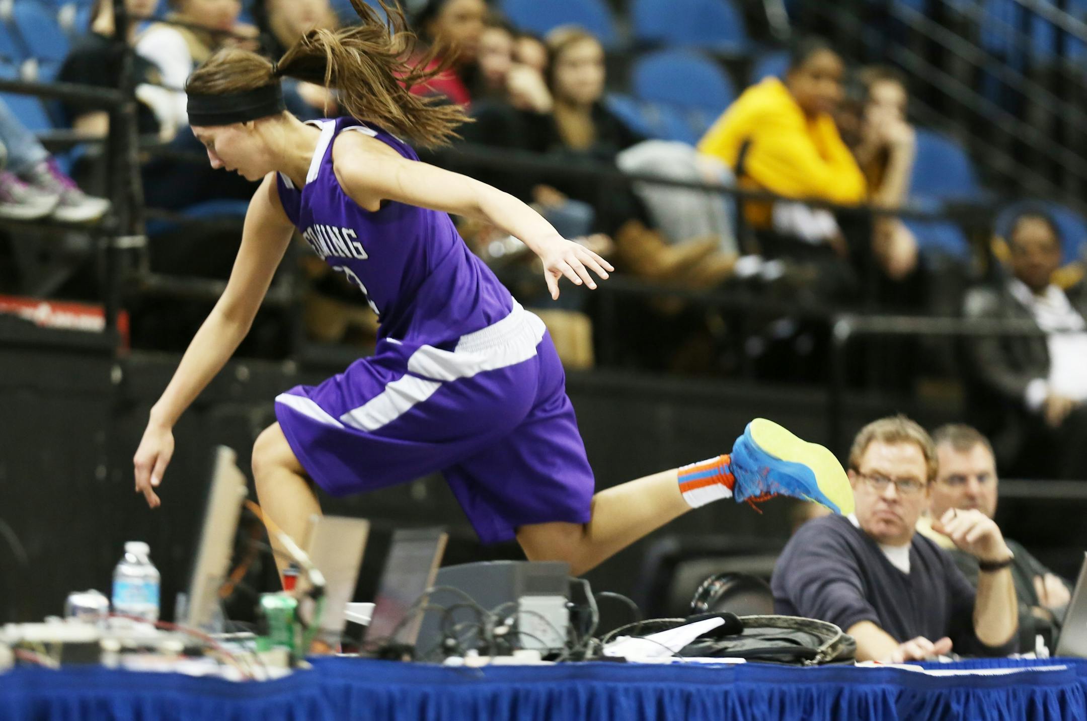 Tesha Buck jumped over the score's table chasing a loose ball .