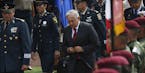 Mexican President Andr&#xe9;s Manuel L&#xf3;pez Obrador, arrives with Secretary of Defense Luis Crescencio Sandoval, left, for a ceremony at the Milit