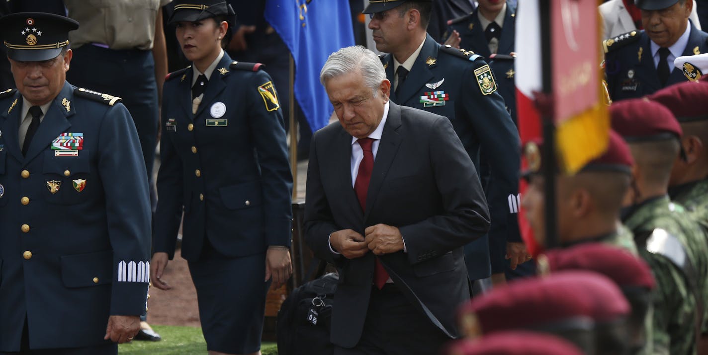 Mexican President Andr&#xe9;s Manuel L&#xf3;pez Obrador, arrives with Secretary of Defense Luis Crescencio Sandoval, left, for a ceremony at the Military Airbase Number 1 in Santa Lucia, on the outskirts of Mexico City, Monday, April 29, 2019. L&#xf3;pez Obrador symbolically launched work on a new airport for Mexico City to replace the nearly half-built $13 billion project he cancelled upon taking office.(AP Photo/Marco Ugarte)