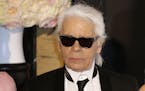 FILE - In this Saturday, March 28, 2015 file photo, Karl Lagerfeld poses for photographers as he arrives at the Rose Ball in Monaco. The Rose Ball is 