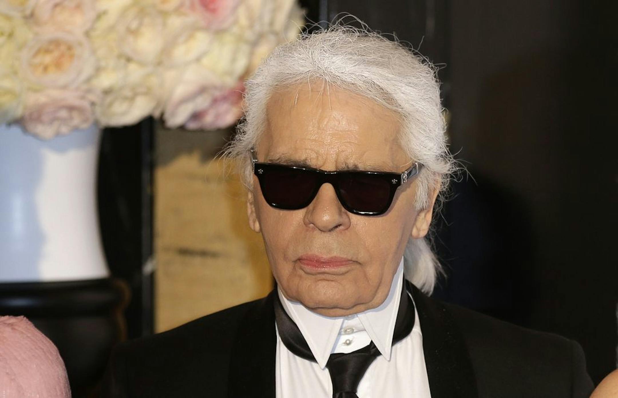 FILE - In this Saturday, March 28, 2015 file photo, Karl Lagerfeld poses for photographers as he arrives at the Rose Ball in Monaco. The Rose Ball is the traditional annual charity event in the Principality of Monaco. Chanel's iconic couturier, Karl Lagerfeld, whose accomplished designs as well as trademark white ponytail, high starched collars and dark enigmatic glasses dominated high fashion for the last 50 years, has died. He was around 85 years old.