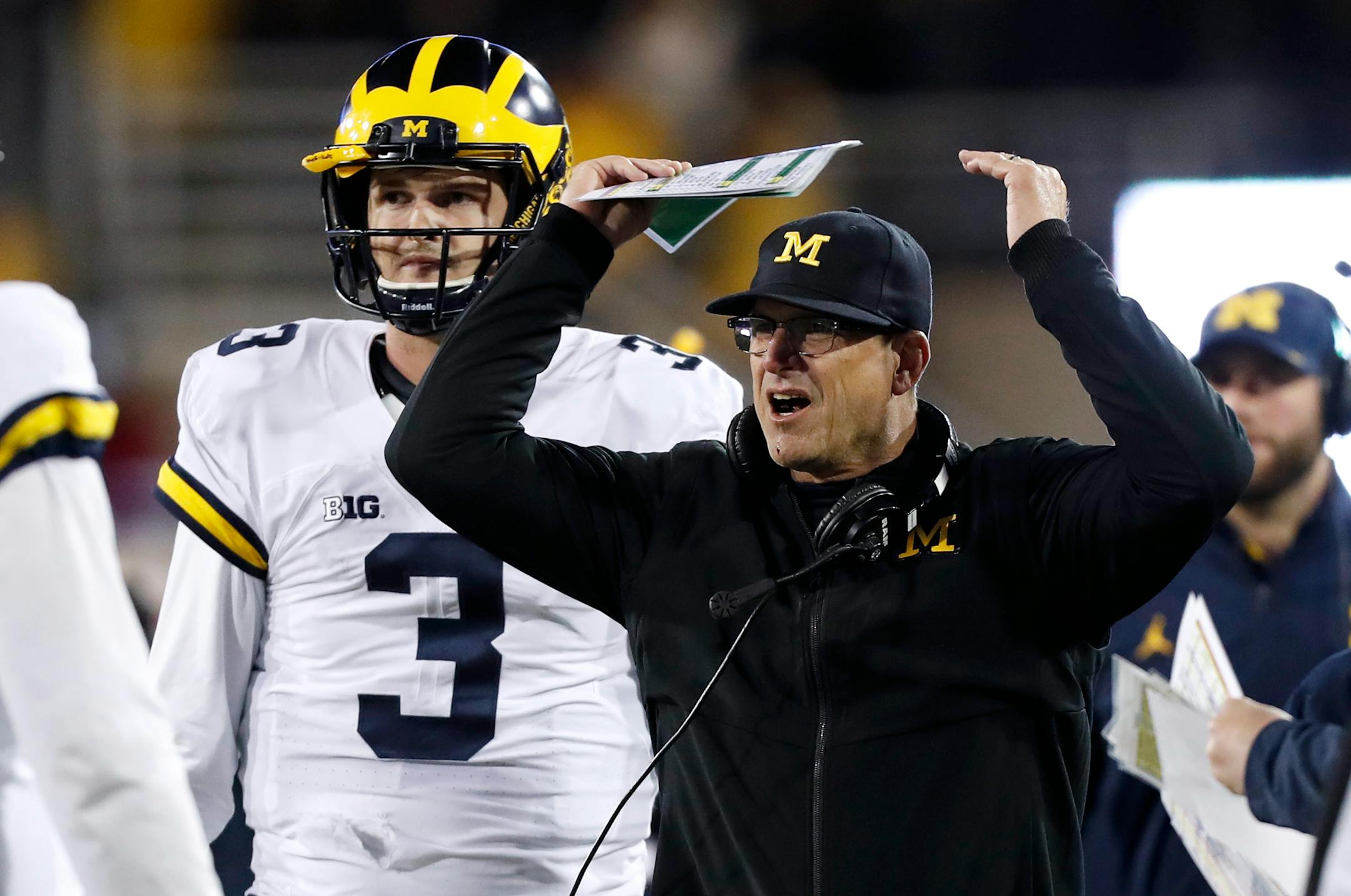 Michigan coach Jim Harbaugh reacts to a call in front of quarterback Wilton Speight (3) during the second half of an NCAA college football game against Iowa, Saturday, Nov. 12, 2016, in Iowa City, Iowa. Iowa won 14-13. (AP Photo/Charlie Neibergall)