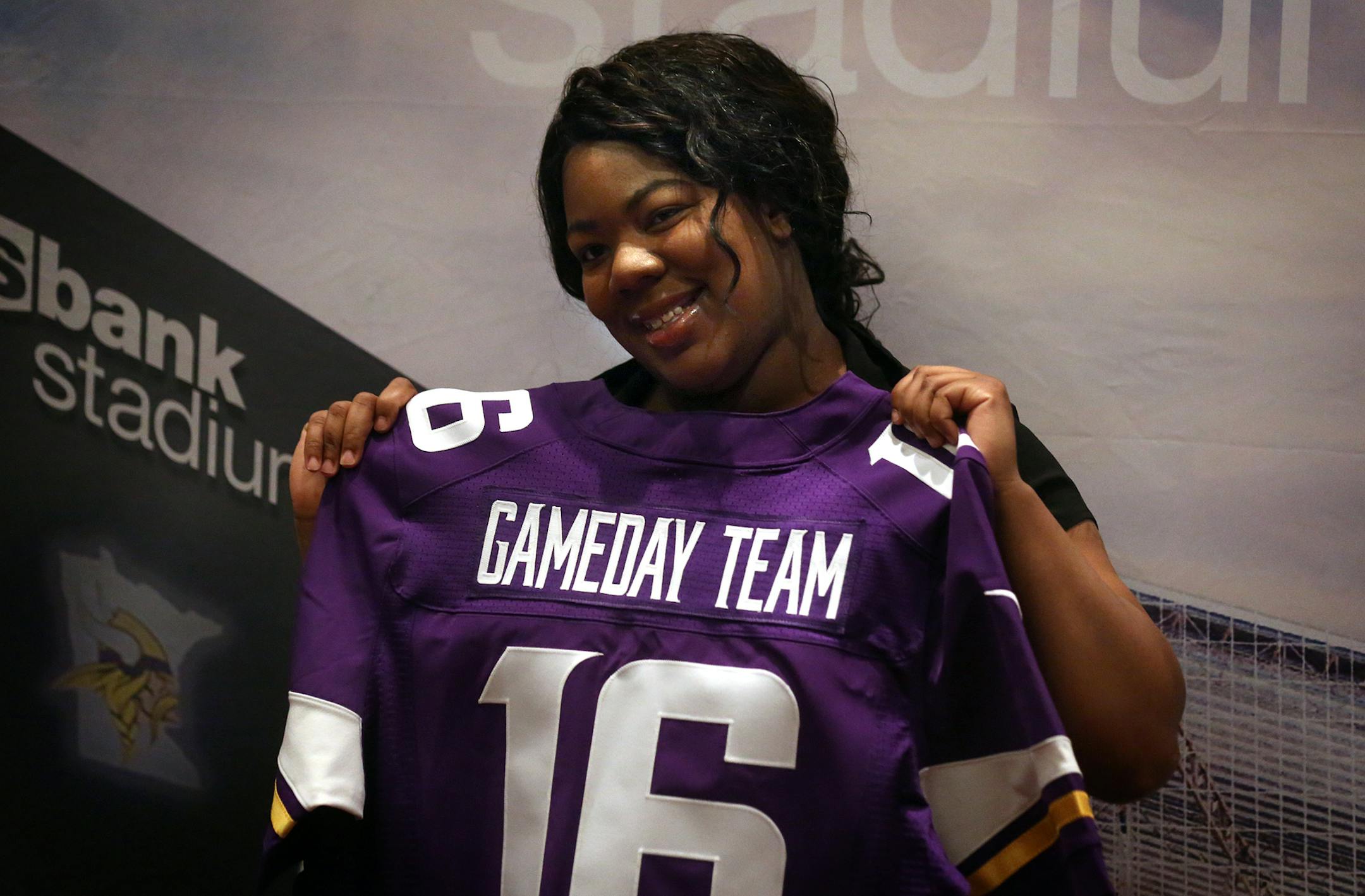 Hope Addison, Minneapolis, posed for a photograph with a jersey at the end of the hiring process. Addison found a job in security at the new stadium.] JIM GEHRZ ï james.gehrz@startribune.com / Minneapolis, MN / April 27, 2016 /9:00 AM ñ BACKGROUND INFORMATION: People came to a hiring fair at the Minneapolis Convention Center Tuesday for a chance to land one of the more than 2,500 jobs available at U.S. Bank Stadium. The first job fair opens at 9 a.m. for the new U.S. Bank Stadium. They