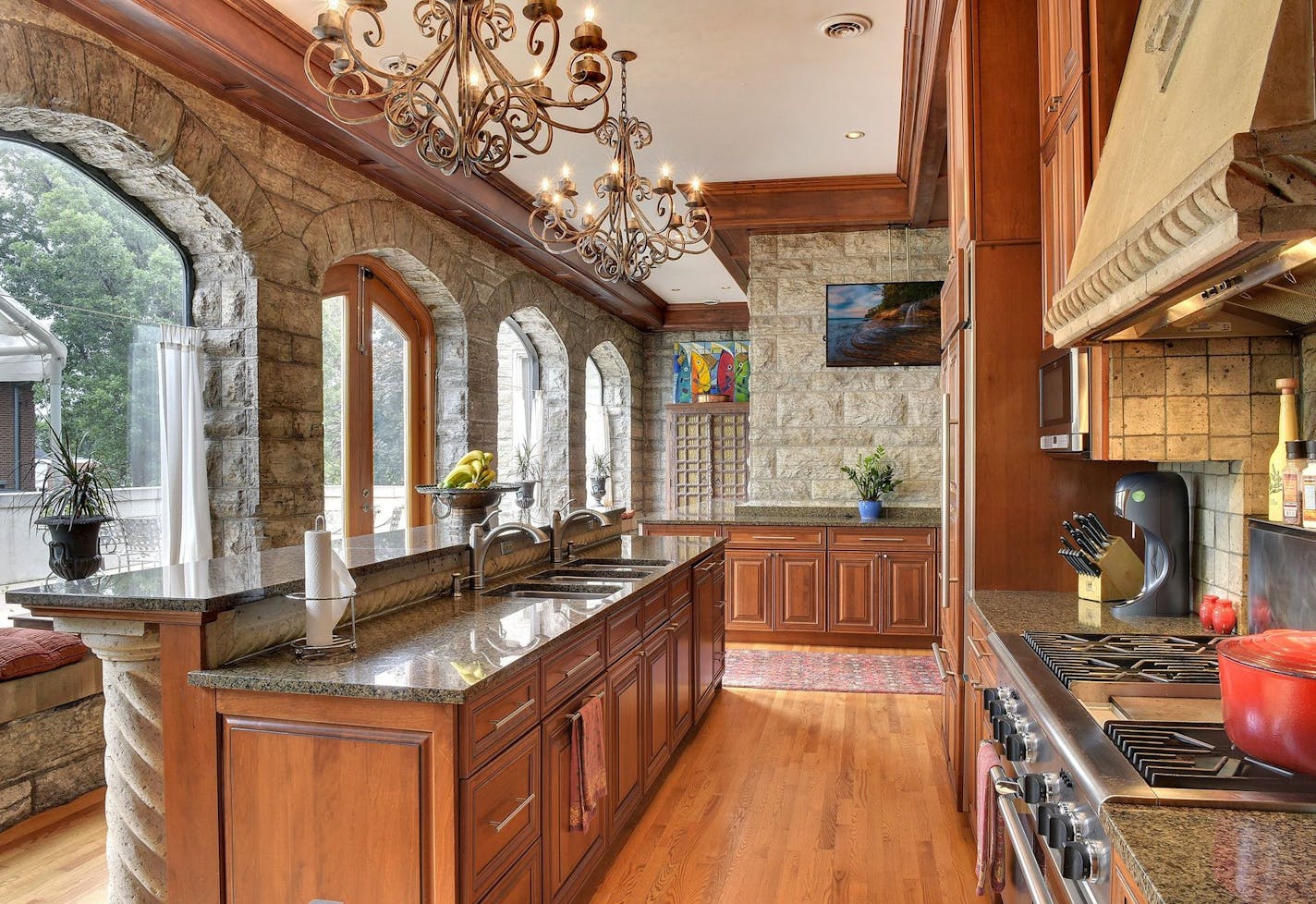 The remodeled kitchen incorporates limestone walls from the home&#x2019;s original porte-cochere.