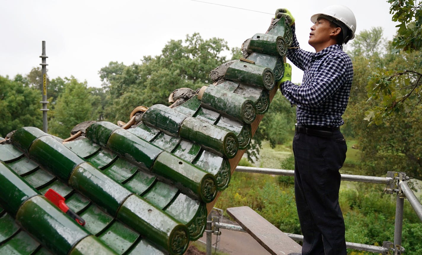 Lou Han Ming worked from scaffolding on the second story of the Chinese pavilion. ] ANTHONY SOUFFLE &#xef; anthony.souffle@startribune.com Workers continued on construction of a Chinese pavilion, along with a Chinese friendship garden, along the shore of Lake Phalen Tuesday, Aug. 28, 2018 in St. Paul, Minn. The pavilion, a replica of the Aiwan Pavilion in Changsha, China, a St. Paul sister city, was built in China, then deconstructed and shipped to the U.S. for assembly here.