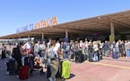 British passengers with Thomas Cook wait in long queue at Antalya airport in Antalya, Turkey, Monday Sept. 23, 2019. Hundreds of thousands of travelle