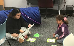 While her mother, Cynthia Gonzalez (not pictured), studied nearby, 6-year-old Mia played a game with NCCC child-care specialist Abi Cardenas, a first-