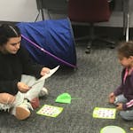 While her mother, Cynthia Gonzalez (not pictured), studied nearby, 6-year-old Mia played a game with NCCC child-care specialist Abi Cardenas, a first-