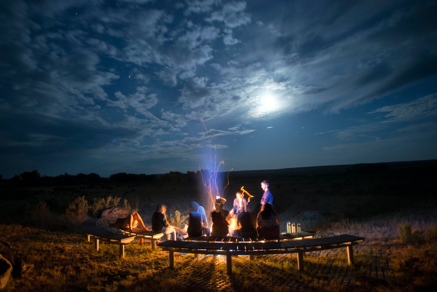 Six New York City high school students spend an evening roasting marshmallows on the American Prairie Reserve in Malta, Mont., July 23, 2015. The six, each of them science scholars and immigrants or children of immigrants who had never been west of Chicago, were on the prairie for experience and insight into their scholastic passions. (Lido Vizzutti/The New York Times)