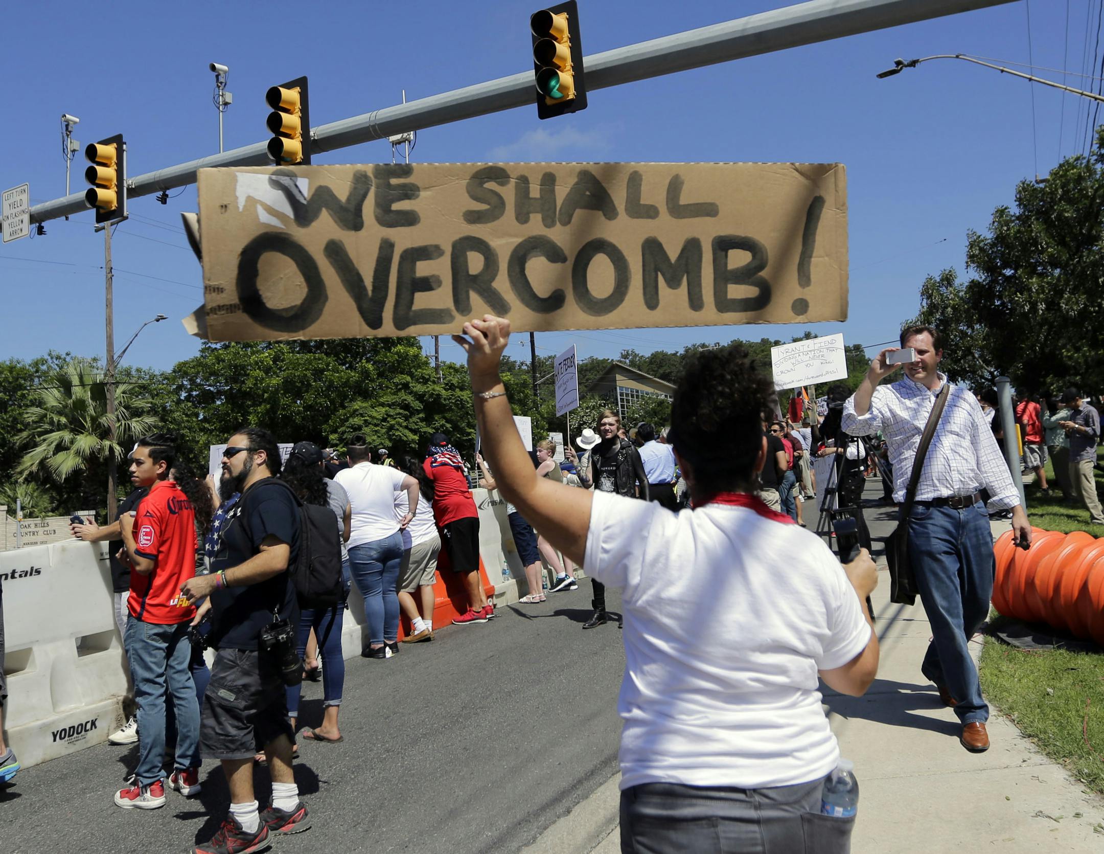 Demonstrators participate in a rally to protest Republican presidential candidate Donald Trump as he attends a private fundraising event, Friday, June 17, 2016, in San Antonio. (AP Photo/Eric Gay)