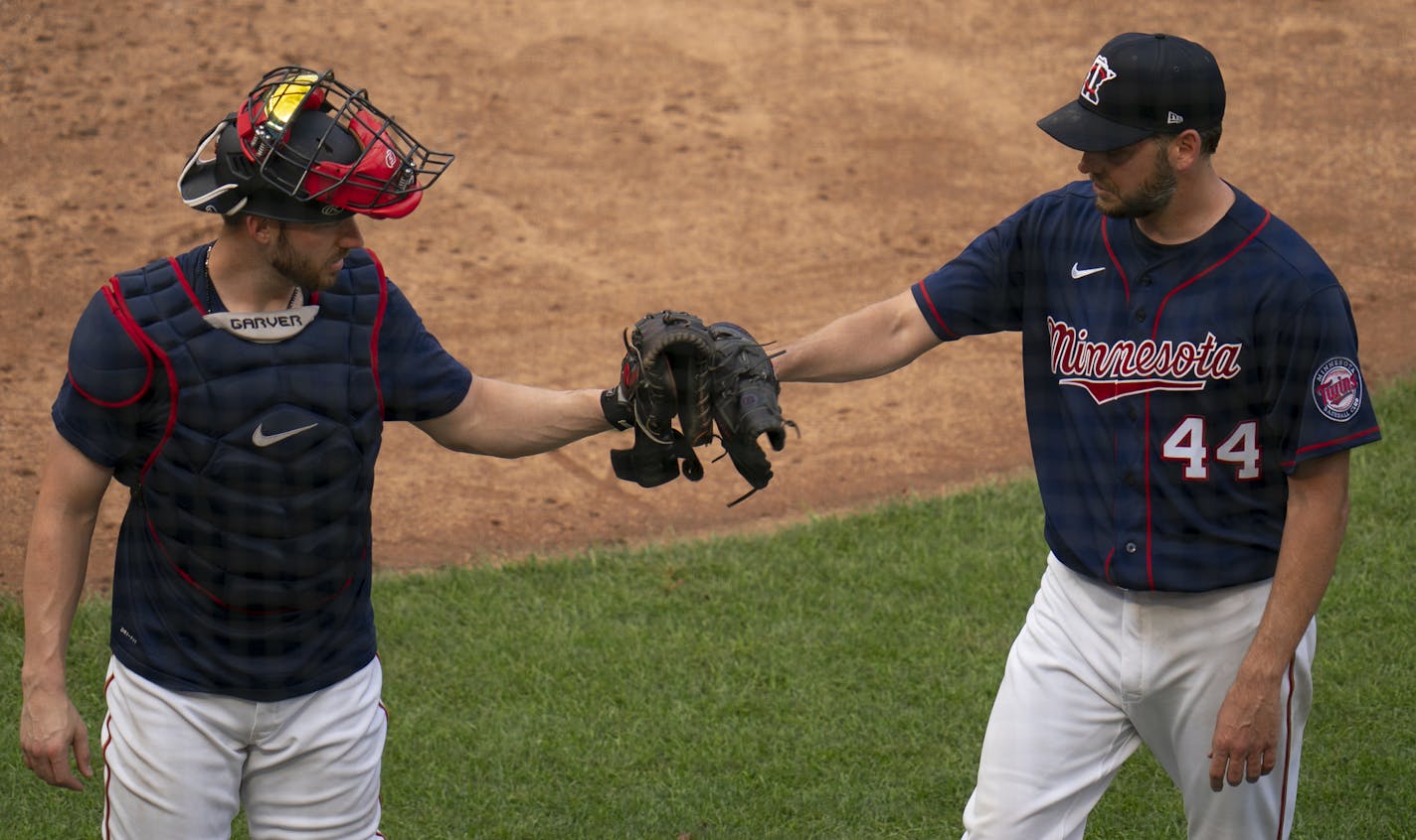 Minnesota Twins pitcher Rich Hill (44) touched gloves with catcher Mitch Garver (8) after throwing live batting practice Monday evening. ] JEFF WHEELER • Jeff.Wheeler@startribune.com The Minnesota Twins held their fourth day of Summer Camp workouts Monday afternoon and evening, July 6, 2020 at Target Field in Minneapolis.