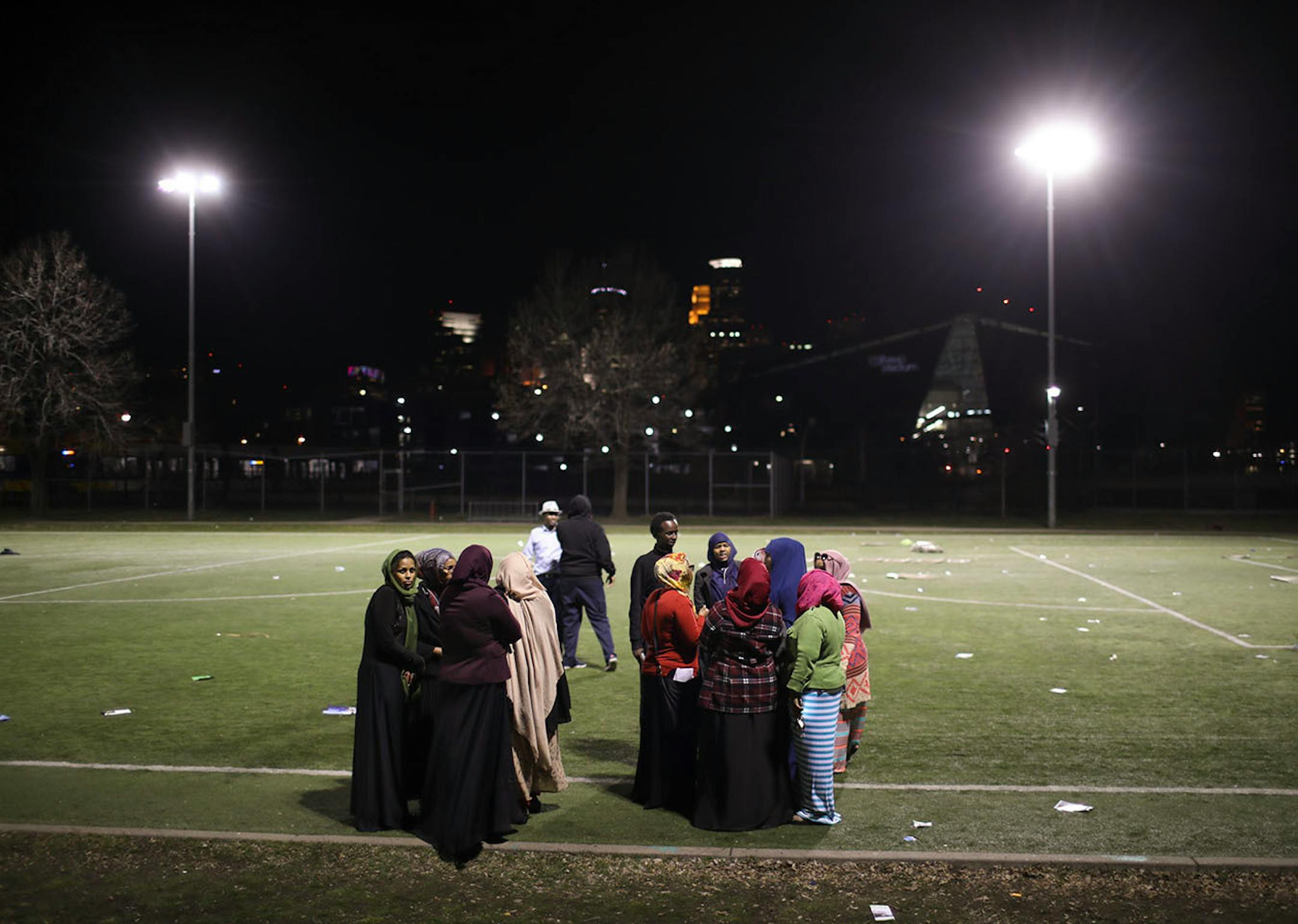 People lingered on the soccer field to discuss the results of the caucus at the Brian Coyle Community Center after most of the crowd had left.