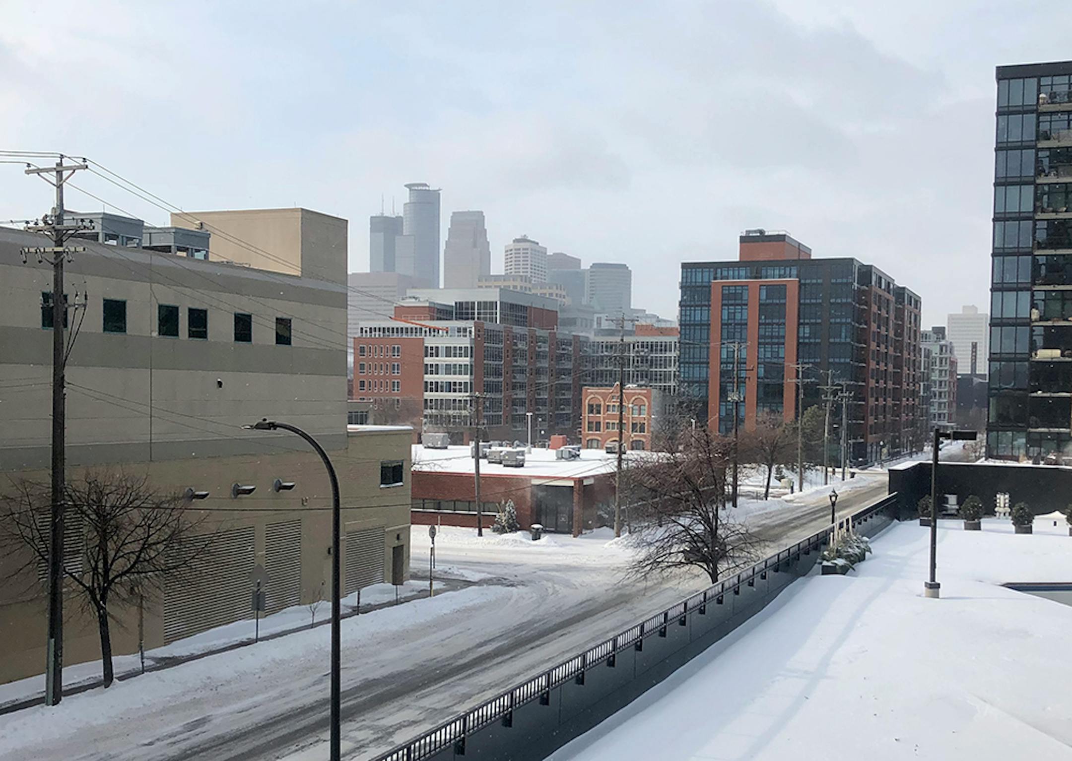 A view of downtown Minneapolis from the Mill District on Saturday. The snow has stopped but winds have increased, and streets remain icy.