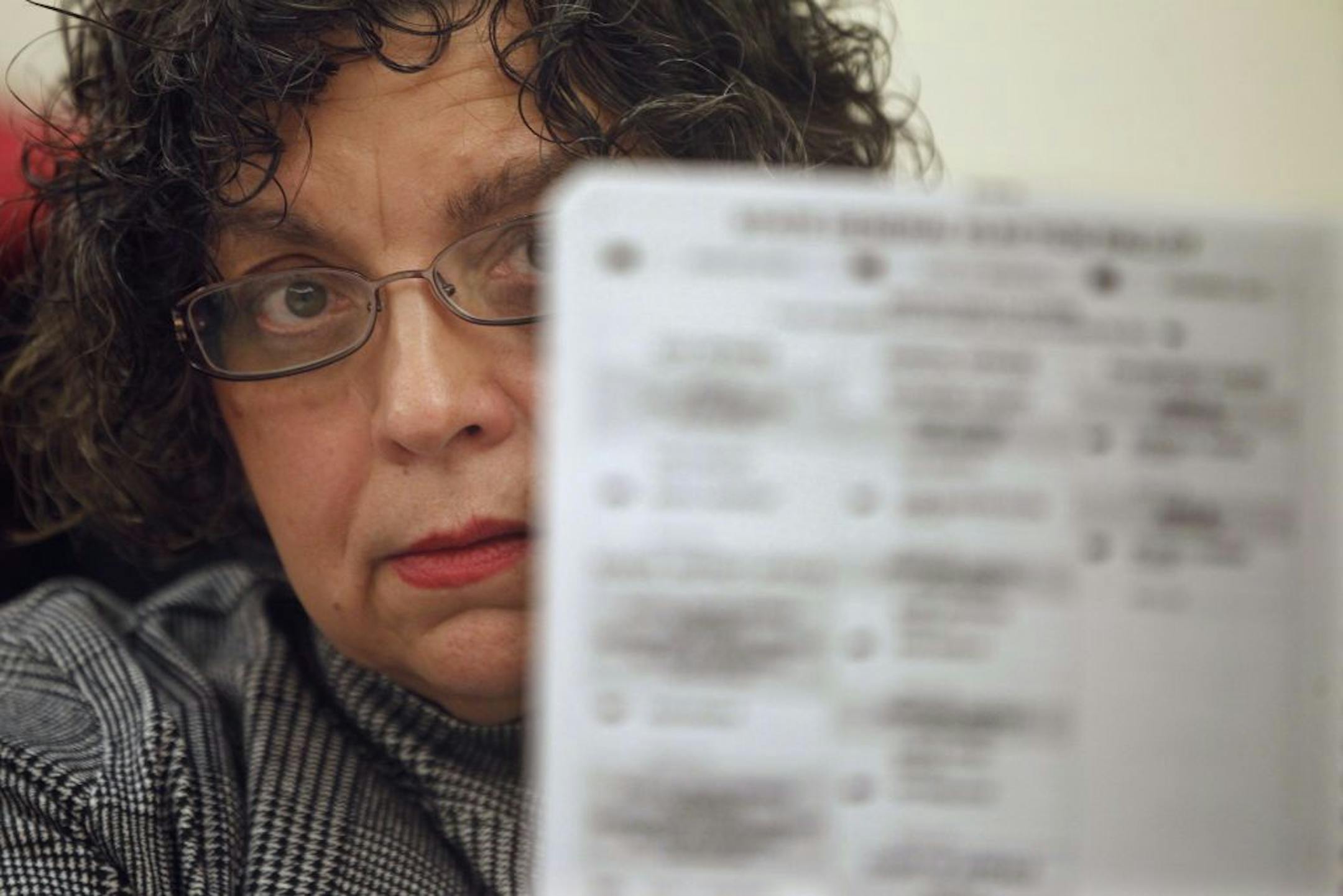 Election worker Bonita Hagel checked out a ballot as the Douglas County legislative recount proceeded vote by vote Wednesday.