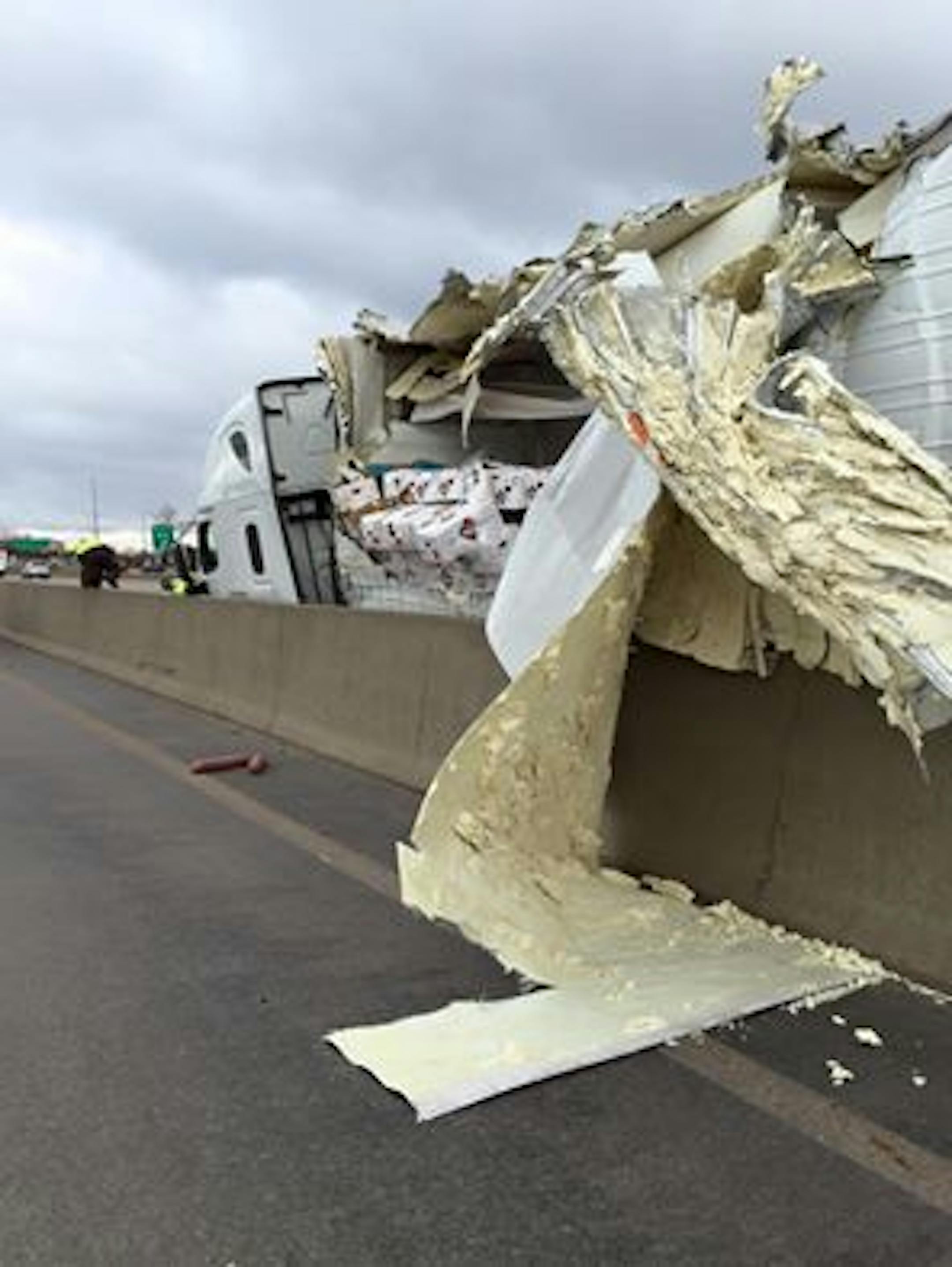 A semitrailer truck carrying sausage sideswiped a concrete median on I-494 in Eden Prairie Monday morning and spilled its load on the freeway
