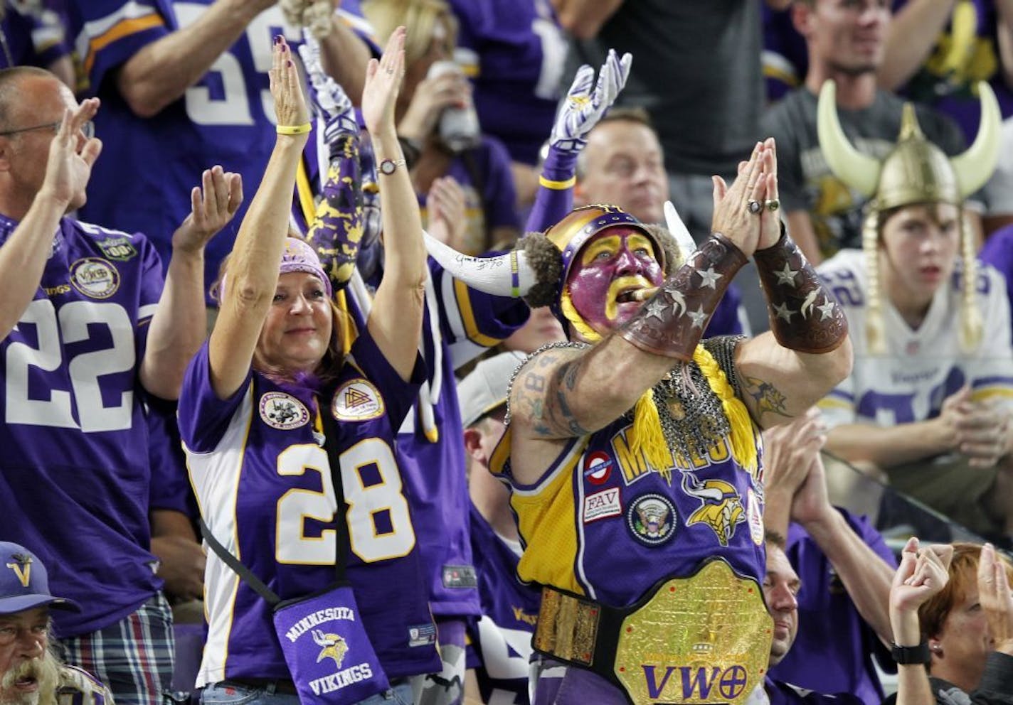 Fans cheer during the second half of an NFL football game between the Minnesota Vikings and the Green Bay Packers Sunday, Sept. 18, 2016, in Minneapolis.