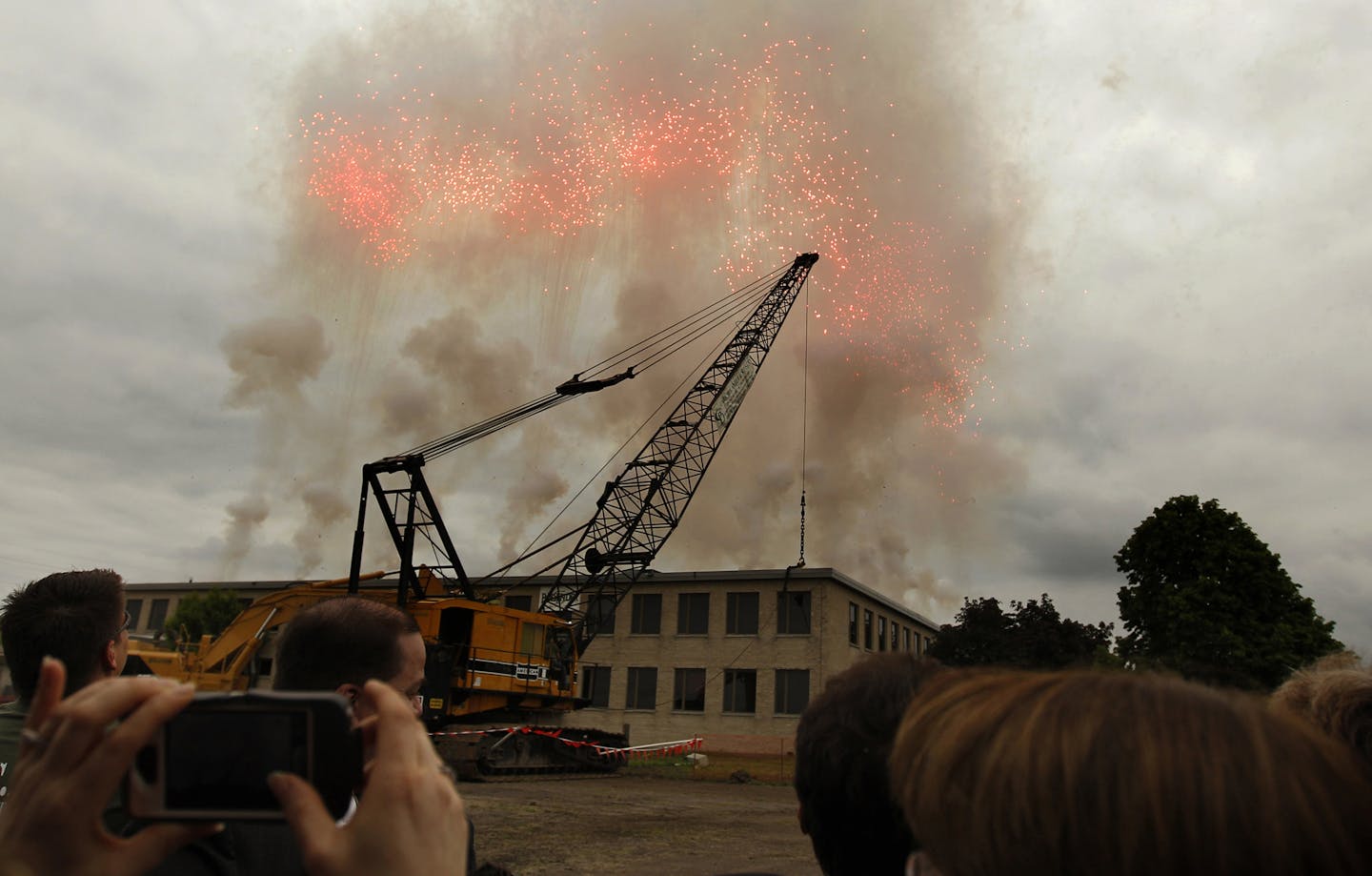 Fireworks shot up from the roof of the former Twin Cities Army Ammunition Plant (TCAAP) in Arden Hills as the building continued to be demolished during a ground breaking ceremony, Friday, June 7, 2013.