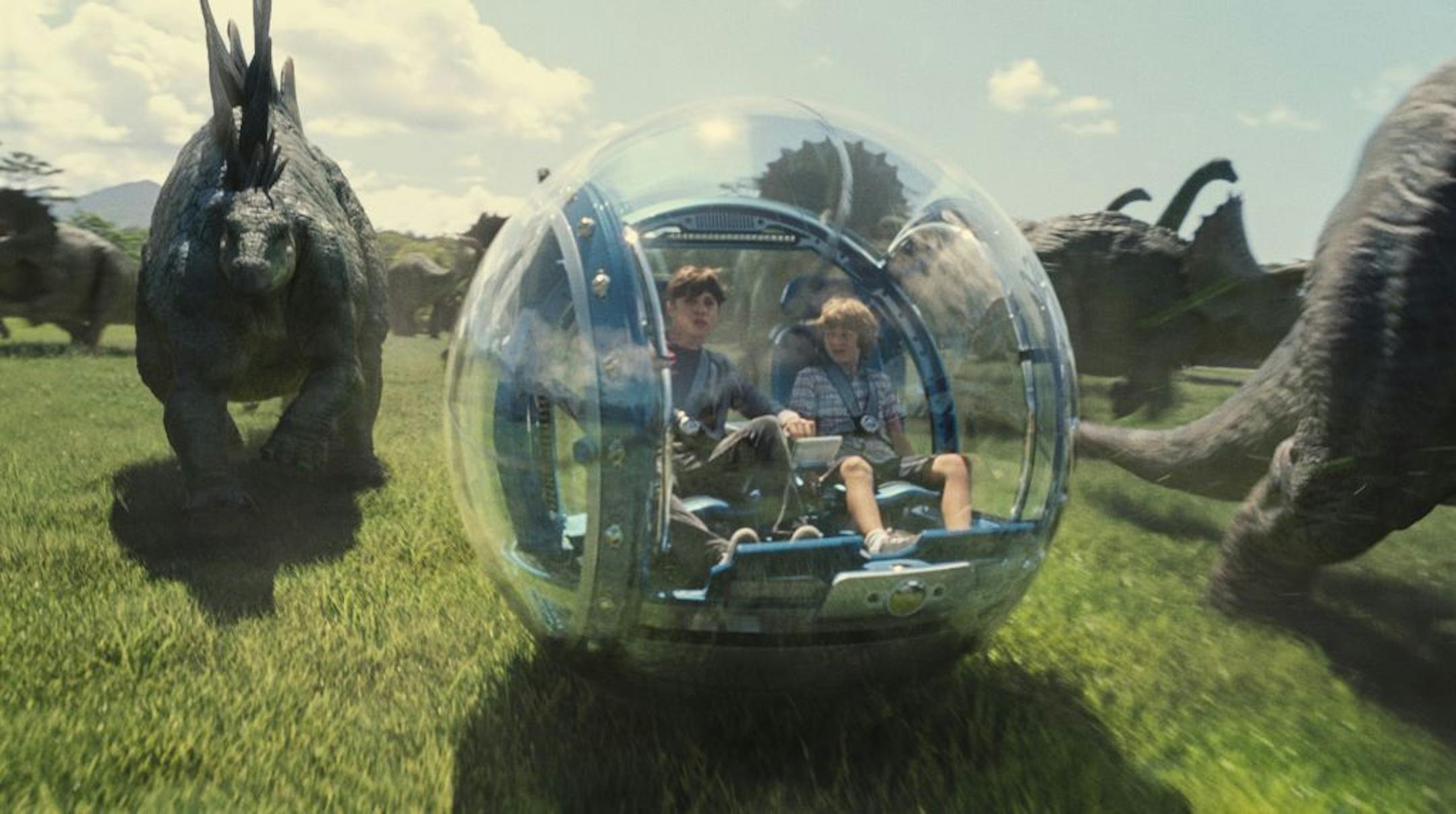 This photo provided by Universal Pictures shows, Nick Robinson, left, as Zach, and Ty Simpkins as Gray, in a scene from the film, "Jurassic World," directed by Colin Trevorrow.