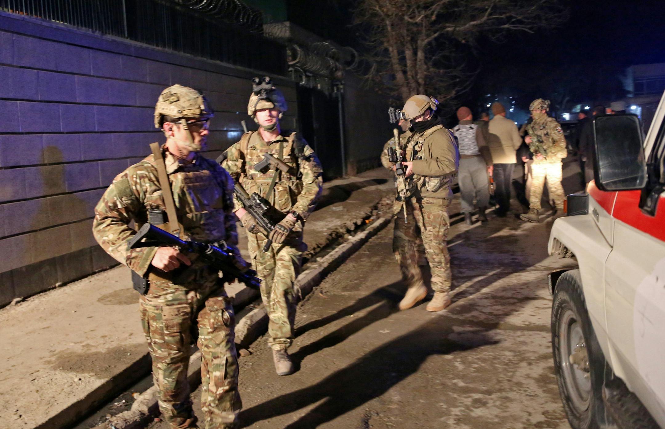 U.S. forces arrive at the site of a suicide attack in Kabul, Afghanistan, Friday, Jan. 17, 2014. Afghan police say a suicide bomber has attacked a restaurant in central Kabul that is popular with officials, foreigners and business people. There were reports of casualties.