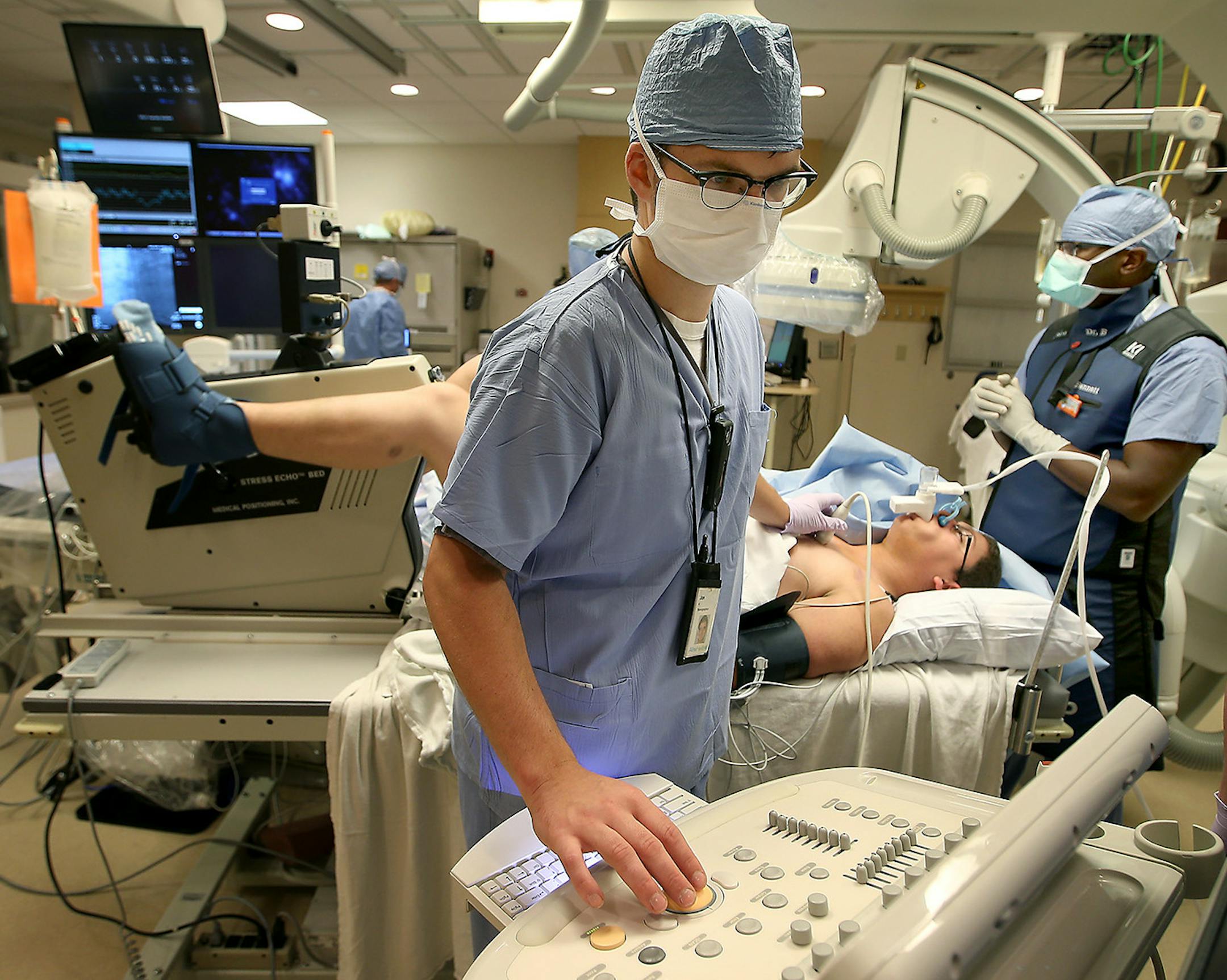 Dr. Mosi Bennett, right, checked Blake Brunner, on table, who is taking a stress test to see whether his implanted heart pump can be removed.