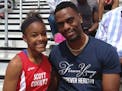 FILE - In this May 3, 2014, file photo, Trinity Gay, a seventh-grader racing for her Scott County High School team, poses for a photo with her father,