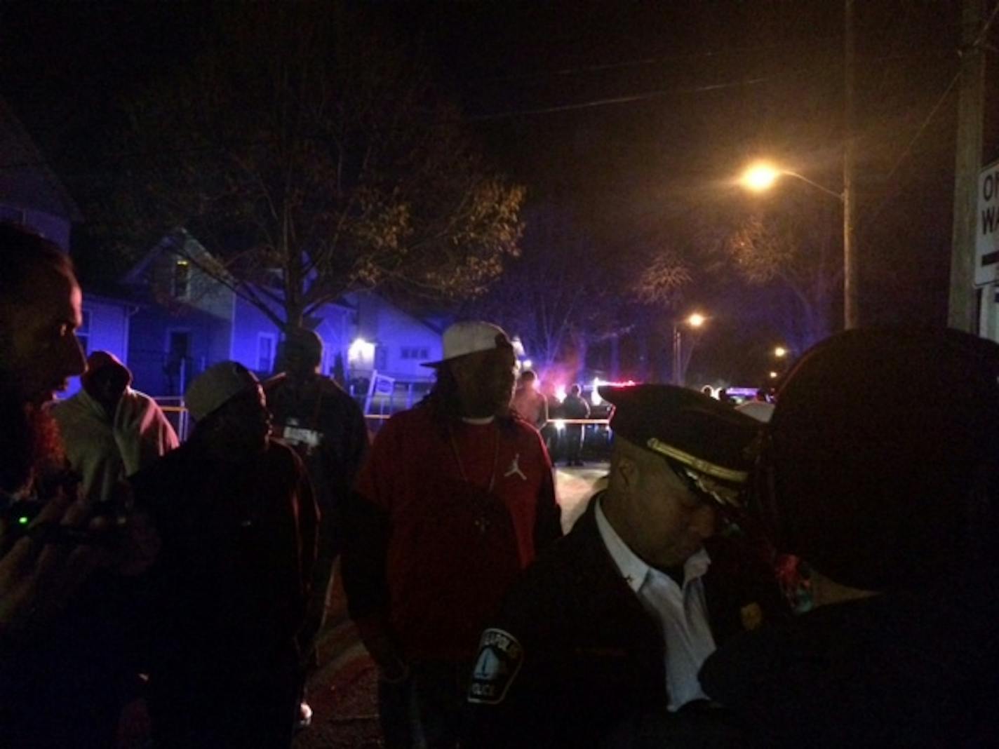 Deputy Police Chief Medaria Arradondo talks with potential witnesses at the site of a shooting Monday night near the Fourth Precinct police headquarters in north Minneapolis.