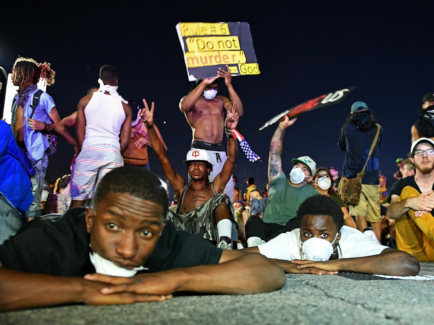 Protestors laid and sat on the ground in front of the police line on I-94 near the Dale St. exit on Saturday night. ] Isaac Hale &#x2022; isaac.hale@startribune.com Protestor's Marched from the governor's mansion to I-94 and occupied the space until about midnight when police officers forced protestors off the interstate. ORG XMIT: MIN1607100152183084